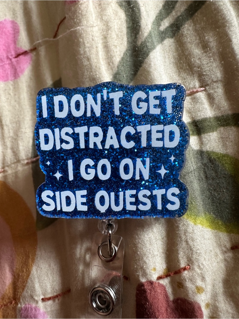 Source Unknown Blue Glitter Badge Reel - Side Quests Quote
